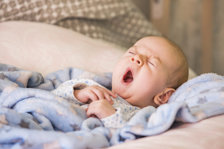 Adorable yawning baby about to nap